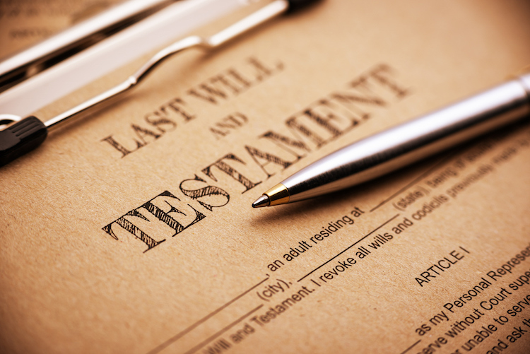 Last will and testament document with a silver pen on top