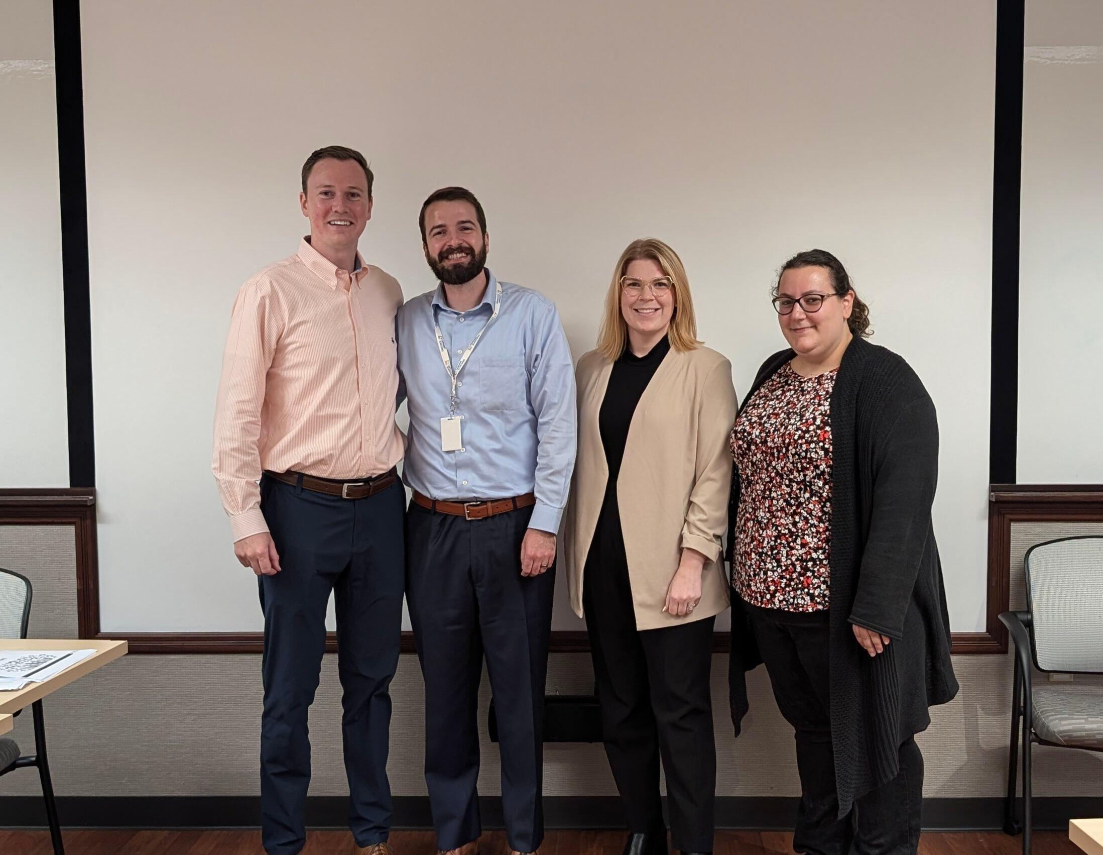 Standing left to right are attorneys Daniel Klementowski, Jason Sikoryak, Alexis Rose, and Jaclyn Terranova against a white background
